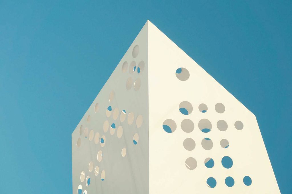 Minimal Building With Holes Under The Blue Sky